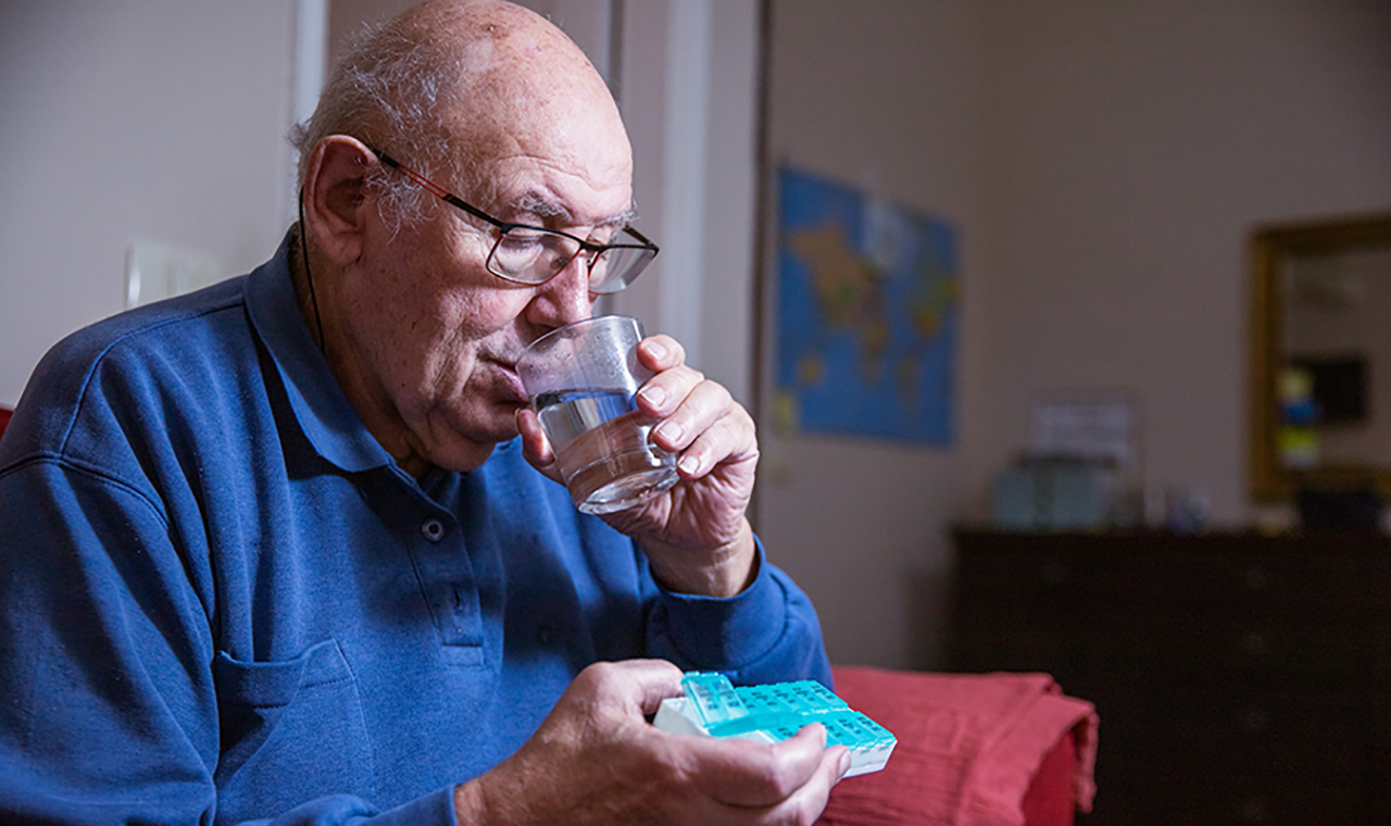 Adulto mayor medicándose